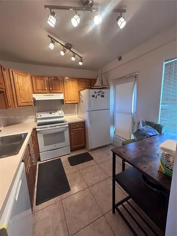 a kitchen with a sink appliances and cabinets