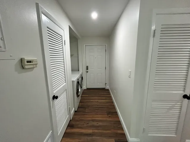 a view of a hallway with a door