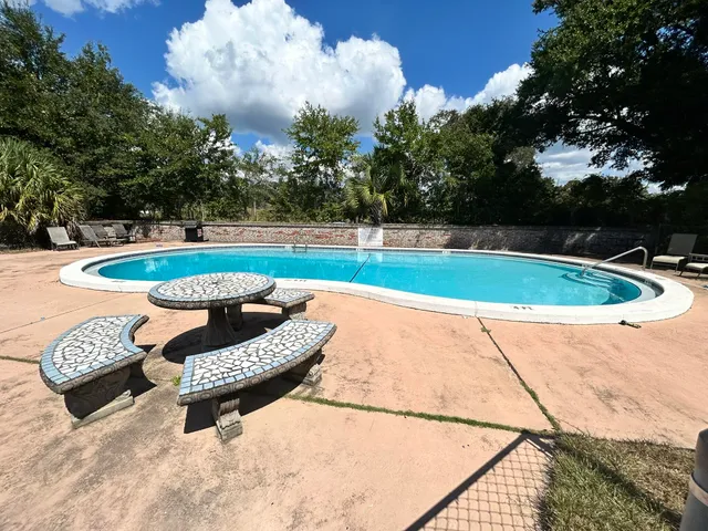 a view of a swimming pool and lounge chair