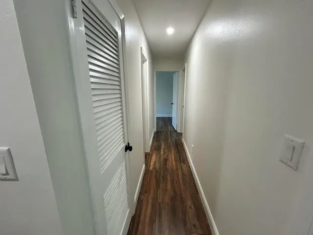 a view of a hallway with a door