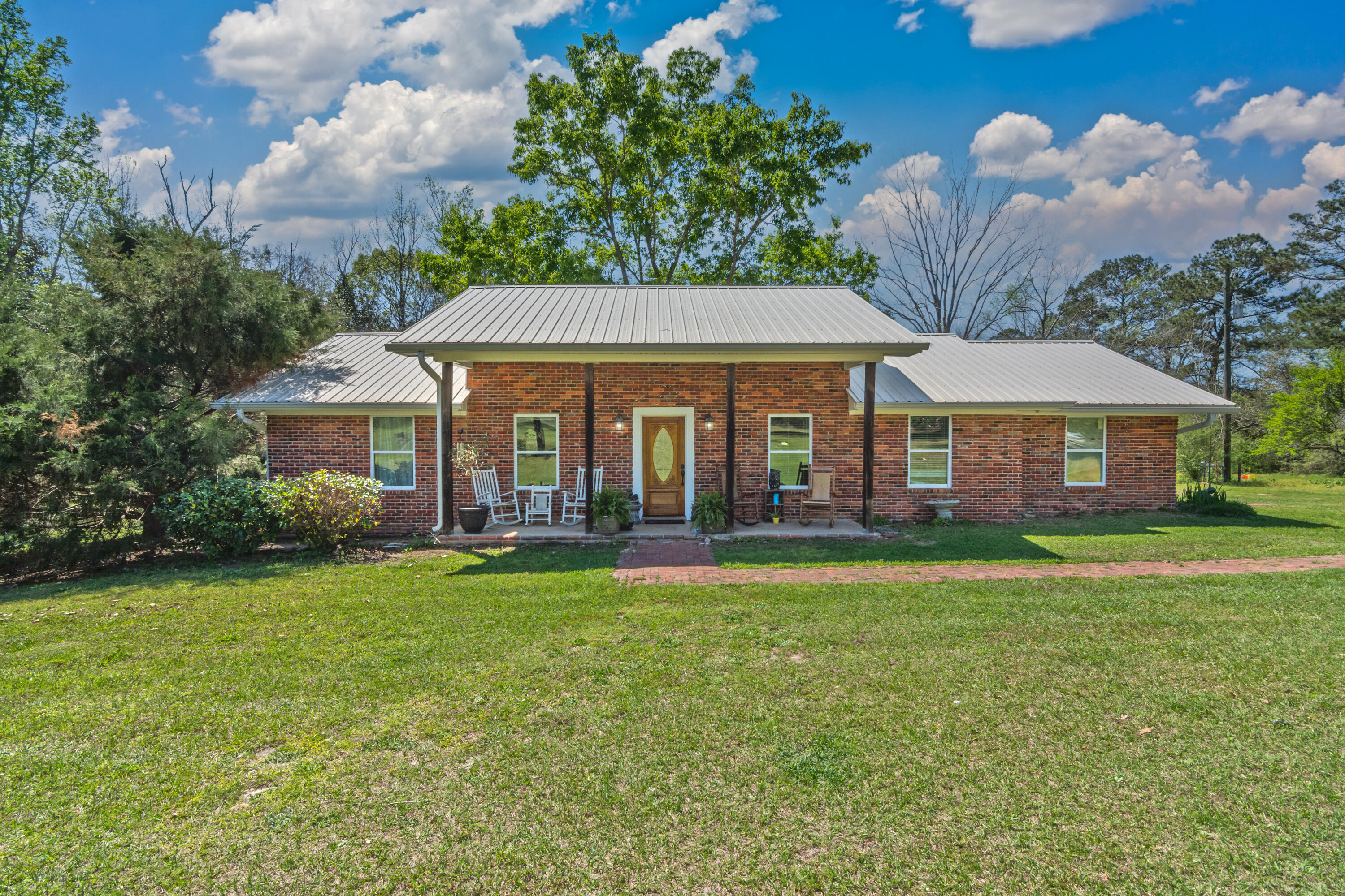 1606 Boy Scout Road DeFuniak Springs, FL 32435 - Photo 1 of 33 a front view of a house with swimming pool having outdoor seating