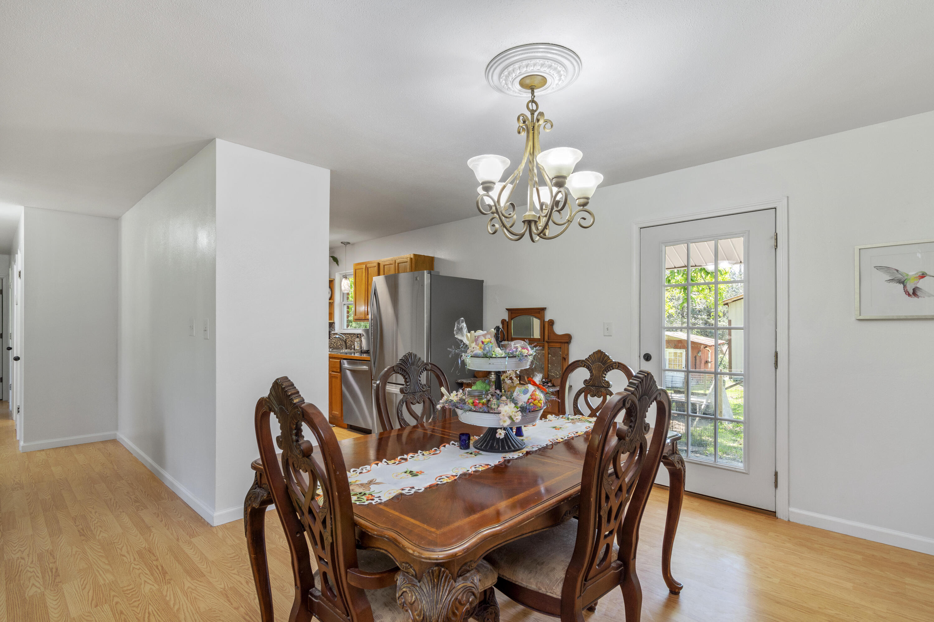 1606 Boy Scout Road DeFuniak Springs, FL 32435 - Photo 18 of 33 a view of a dining room with furniture a chandelier and wooden floor
