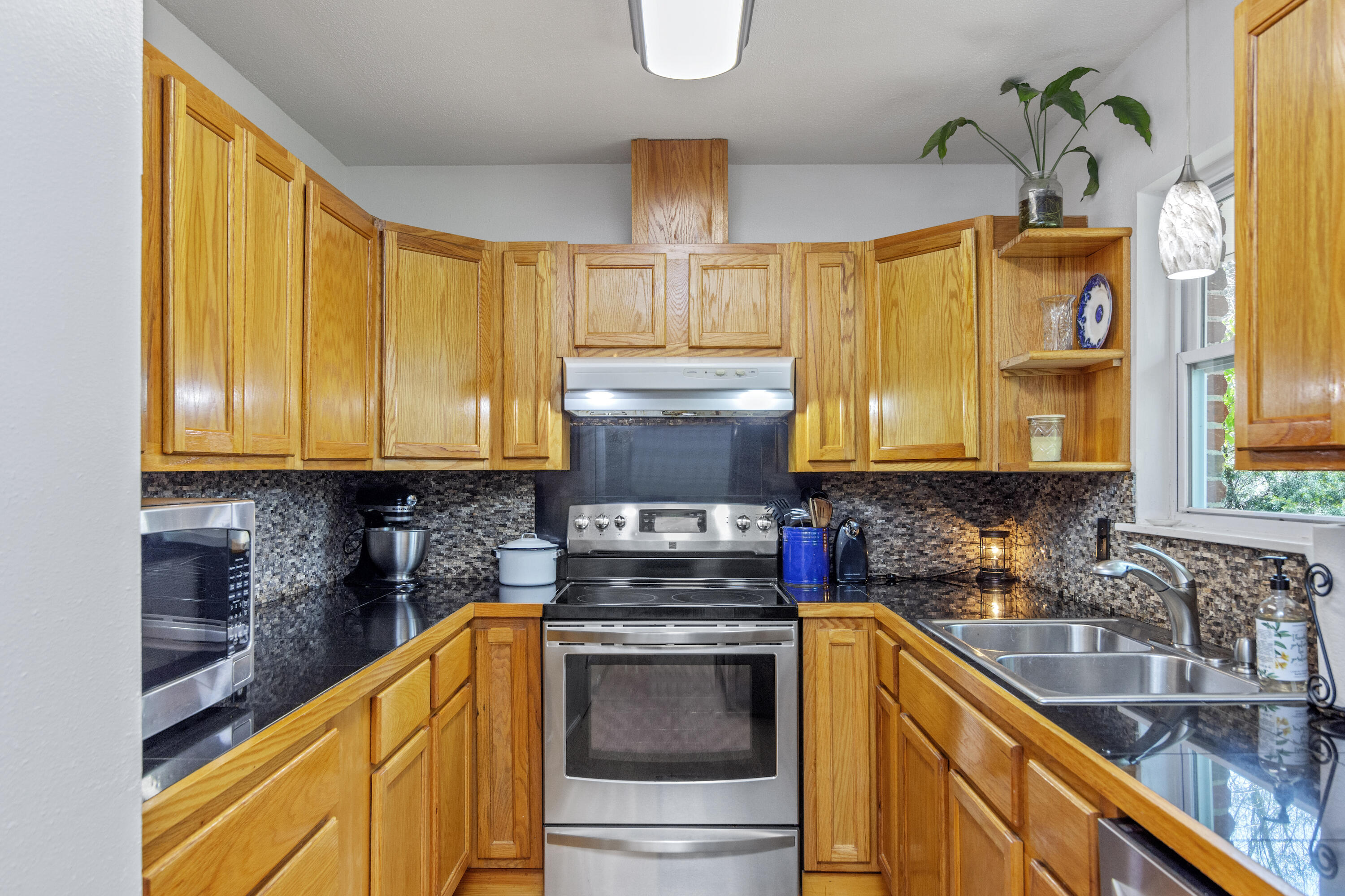 1606 Boy Scout Road DeFuniak Springs, FL 32435 - Photo 20 of 33 a kitchen with stainless steel appliances granite countertop a sink a stove and a refrigerator