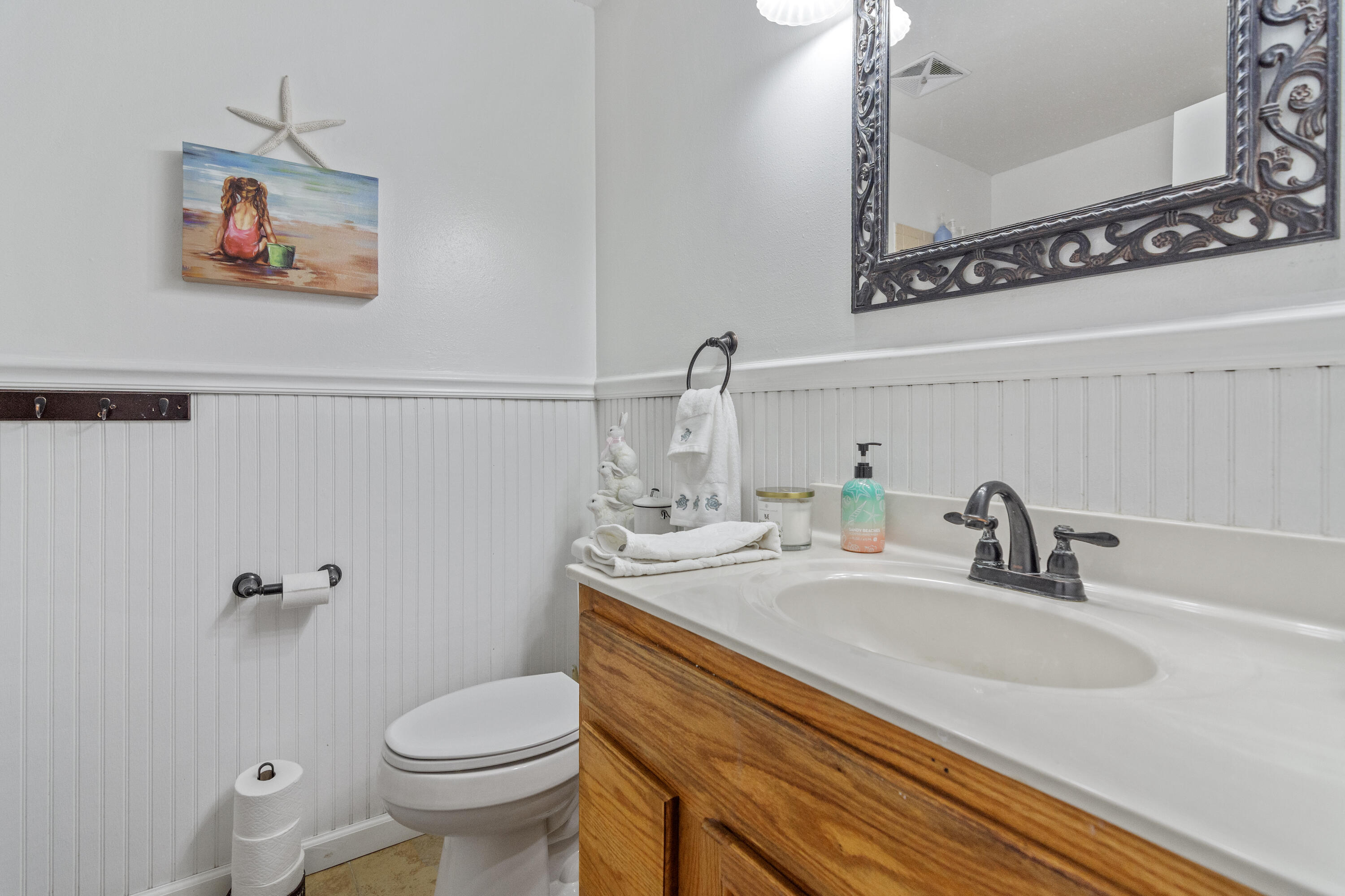 1606 Boy Scout Road DeFuniak Springs, FL 32435 - Photo 23 of 33 a bathroom with a sink a toilet and mirror