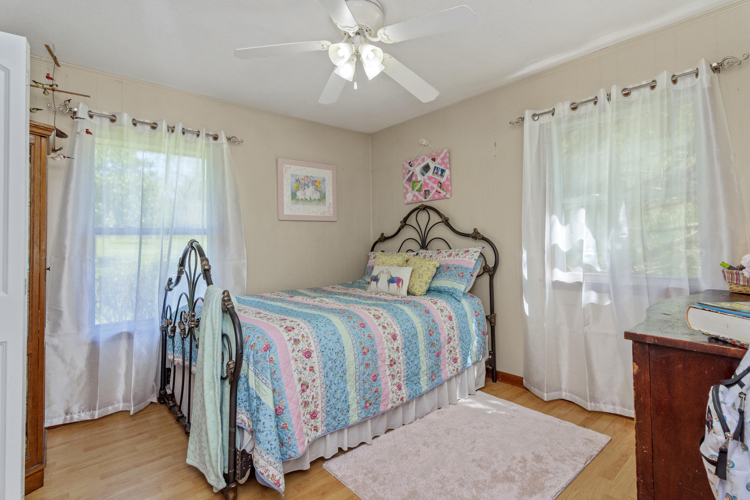 1606 Boy Scout Road DeFuniak Springs, FL 32435 - Photo 25 of 33 a bedroom with a bed and a chandelier
