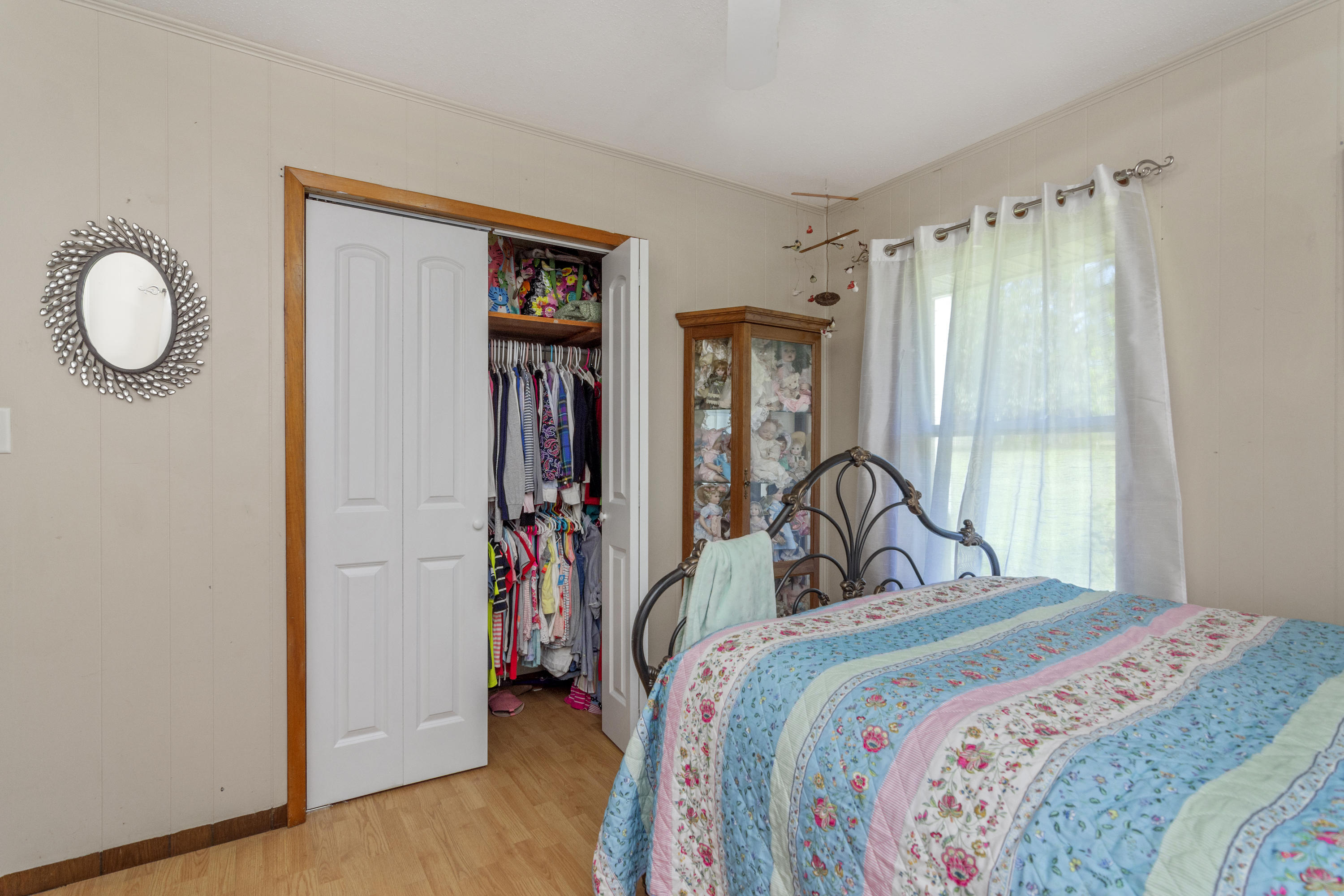 1606 Boy Scout Road DeFuniak Springs, FL 32435 - Photo 26 of 33 a bedroom with a bed and a large mirror next to a window