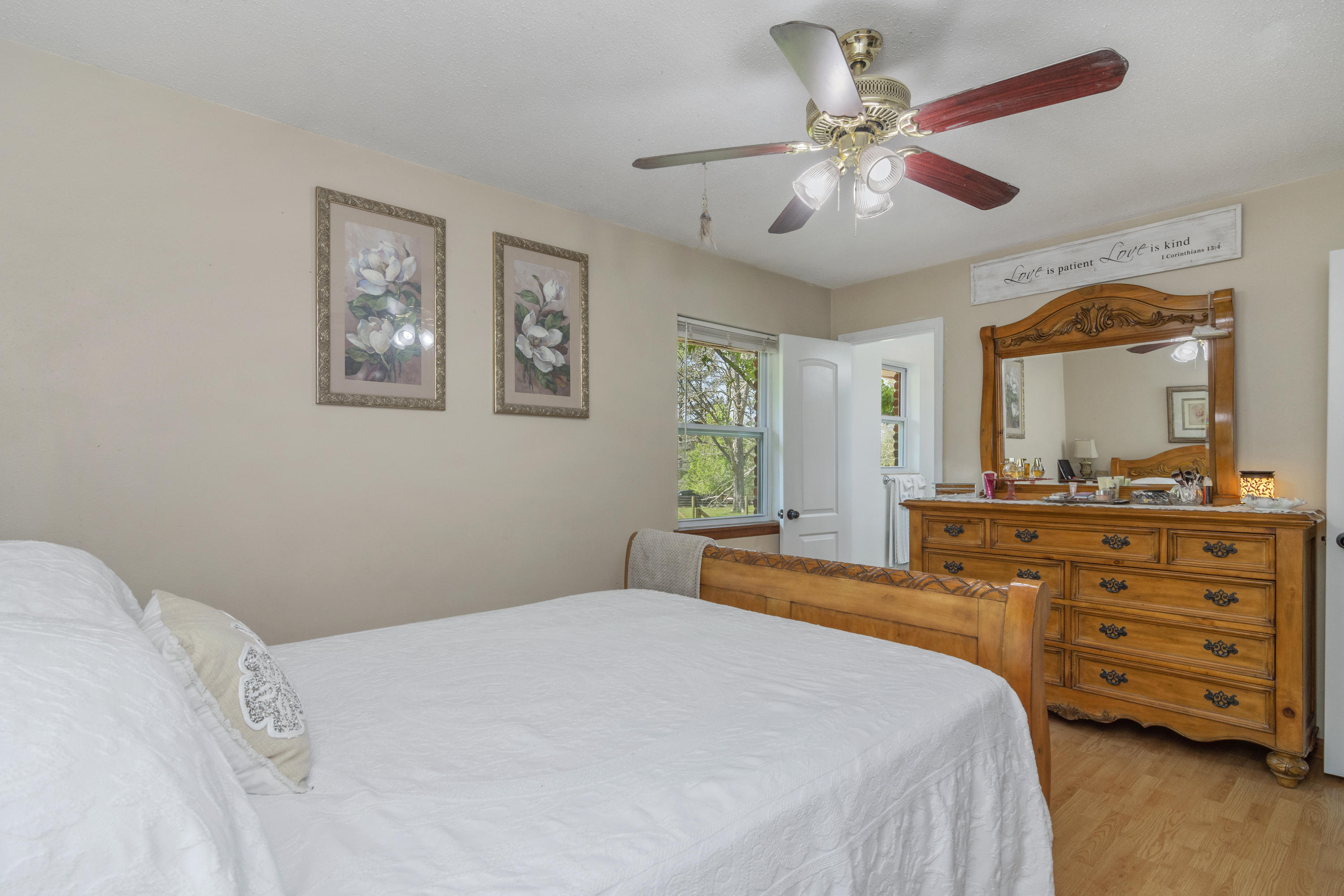 1606 Boy Scout Road DeFuniak Springs, FL 32435 - Photo 28 of 33 a bedroom with a bed and a mirror on the dresser