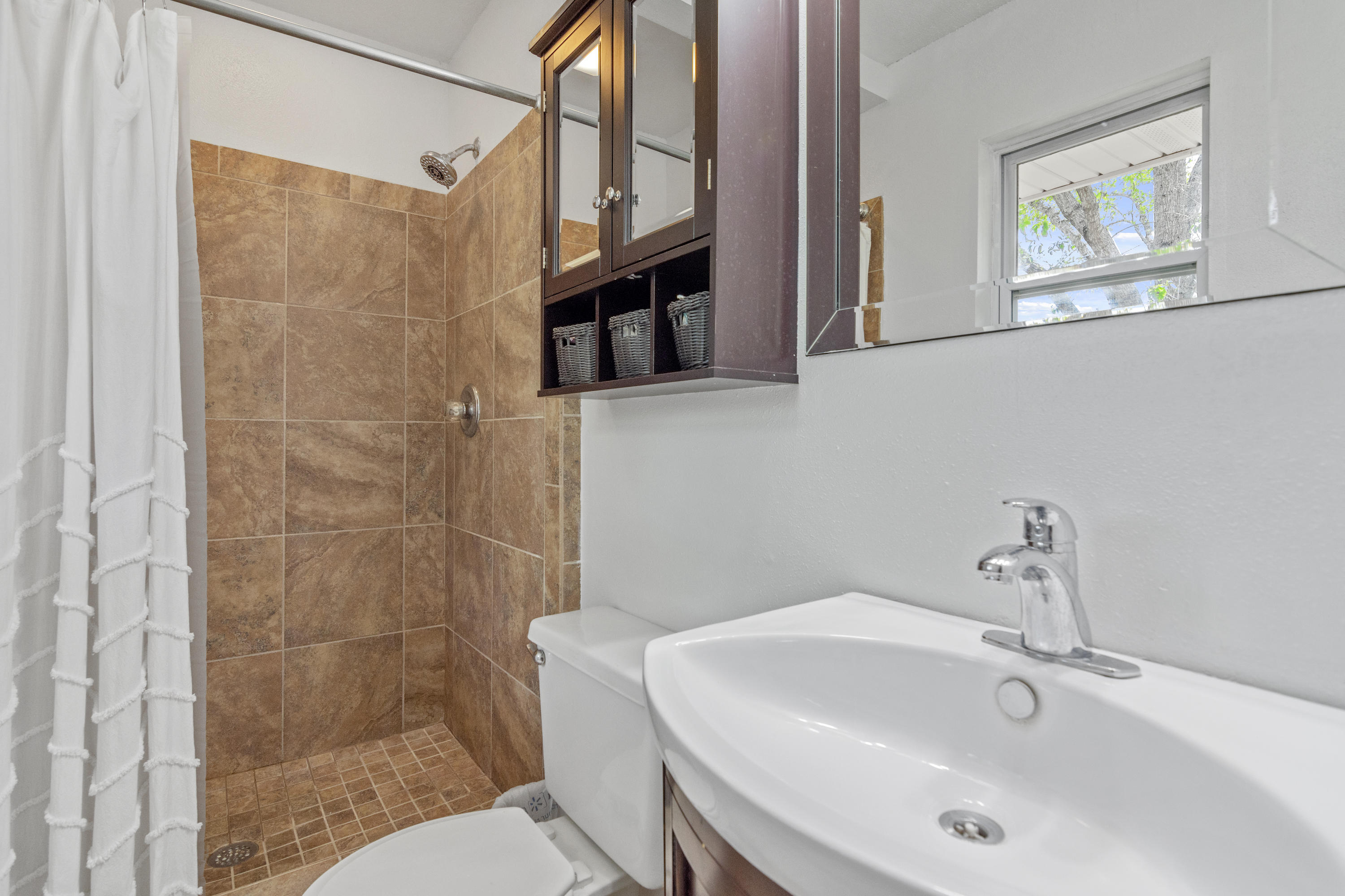 1606 Boy Scout Road DeFuniak Springs, FL 32435 - Photo 29 of 33 a bathroom with a sink a toilet and shower