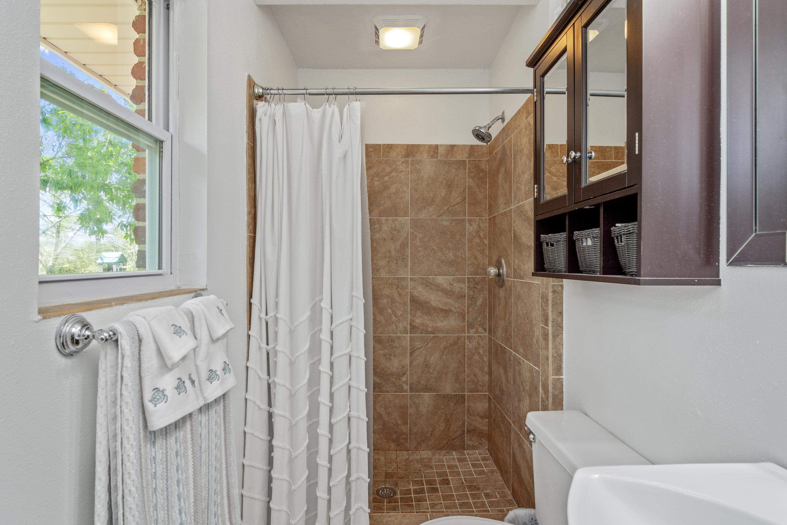 1606 Boy Scout Road DeFuniak Springs, FL 32435 - Photo 30 of 33 a bathroom with a shower curtain and a window