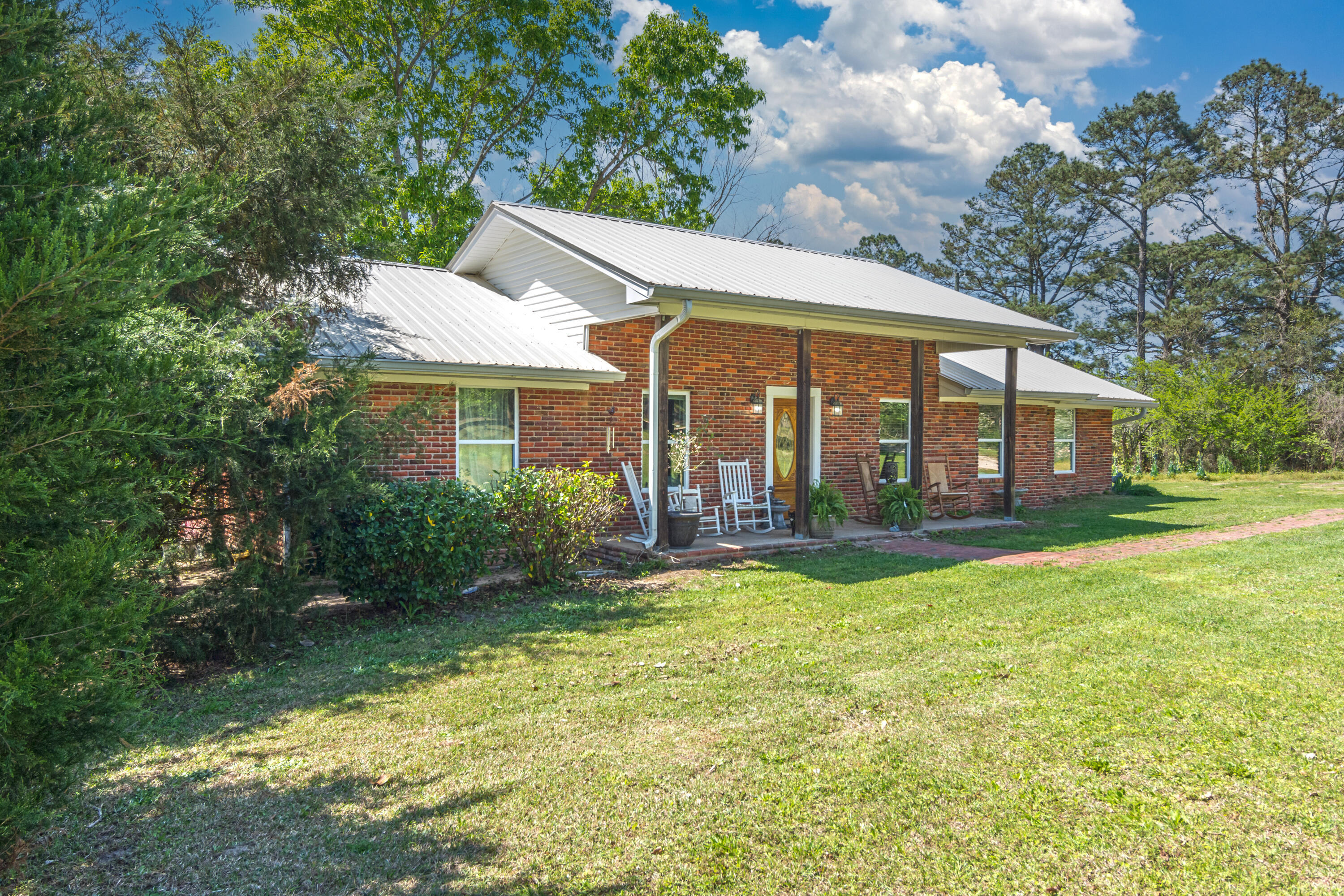 1606 Boy Scout Road DeFuniak Springs, FL 32435 - Photo 4 of 33 a view of a house with a yard and sitting area