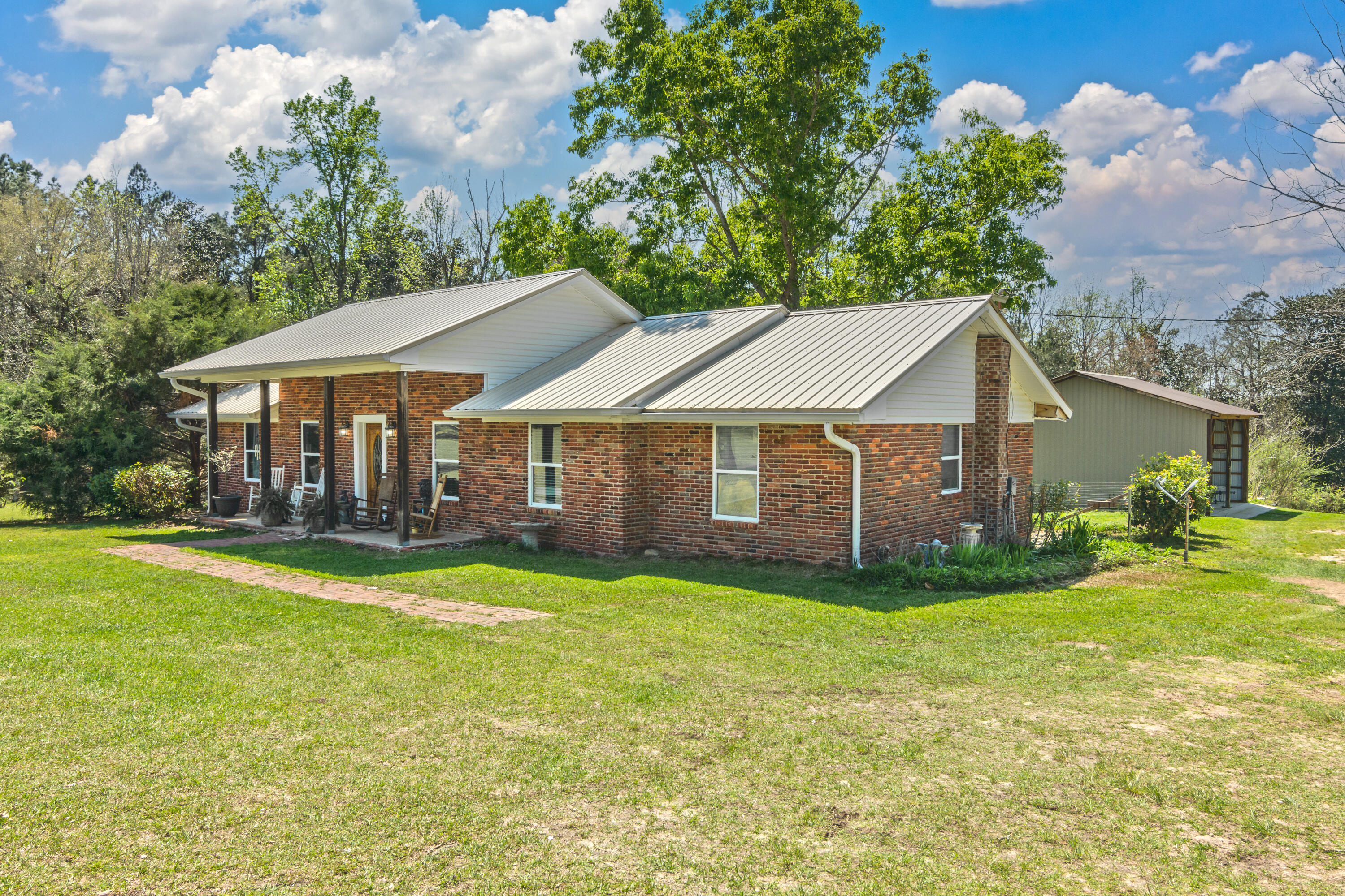 1606 Boy Scout Road DeFuniak Springs, FL 32435 - Photo 5 of 33 a view of a house with a yard and sitting area