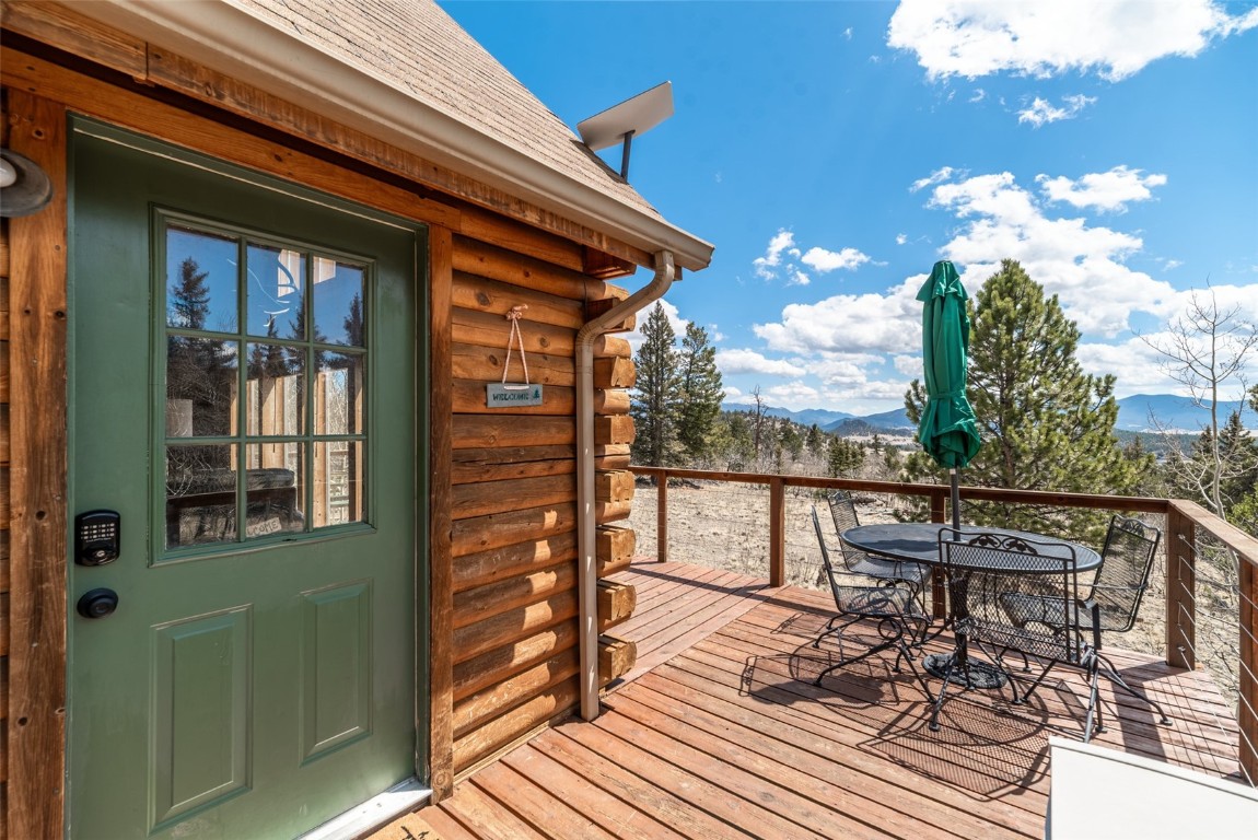 858 Red Cloud Road Como, CO 80456 - Photo 10 of 40 a view of a balcony with wooden floor and outdoor seating
