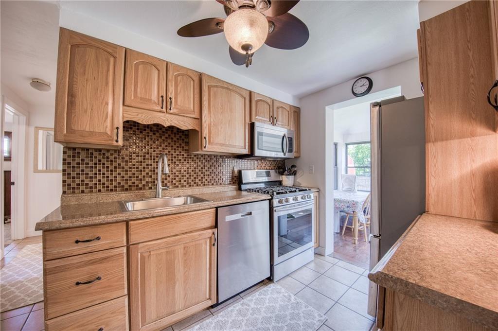 902 Foster Street Clairton, PA 15025 - Photo 8 of 45 Kitchen with oak cabinets and stainless steel appliances