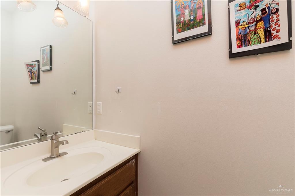 1213 Rhett Drive Pharr, TX 78577 - Photo 17 of 19 Convenient half bathroom with a single vanity and decorative lighting.