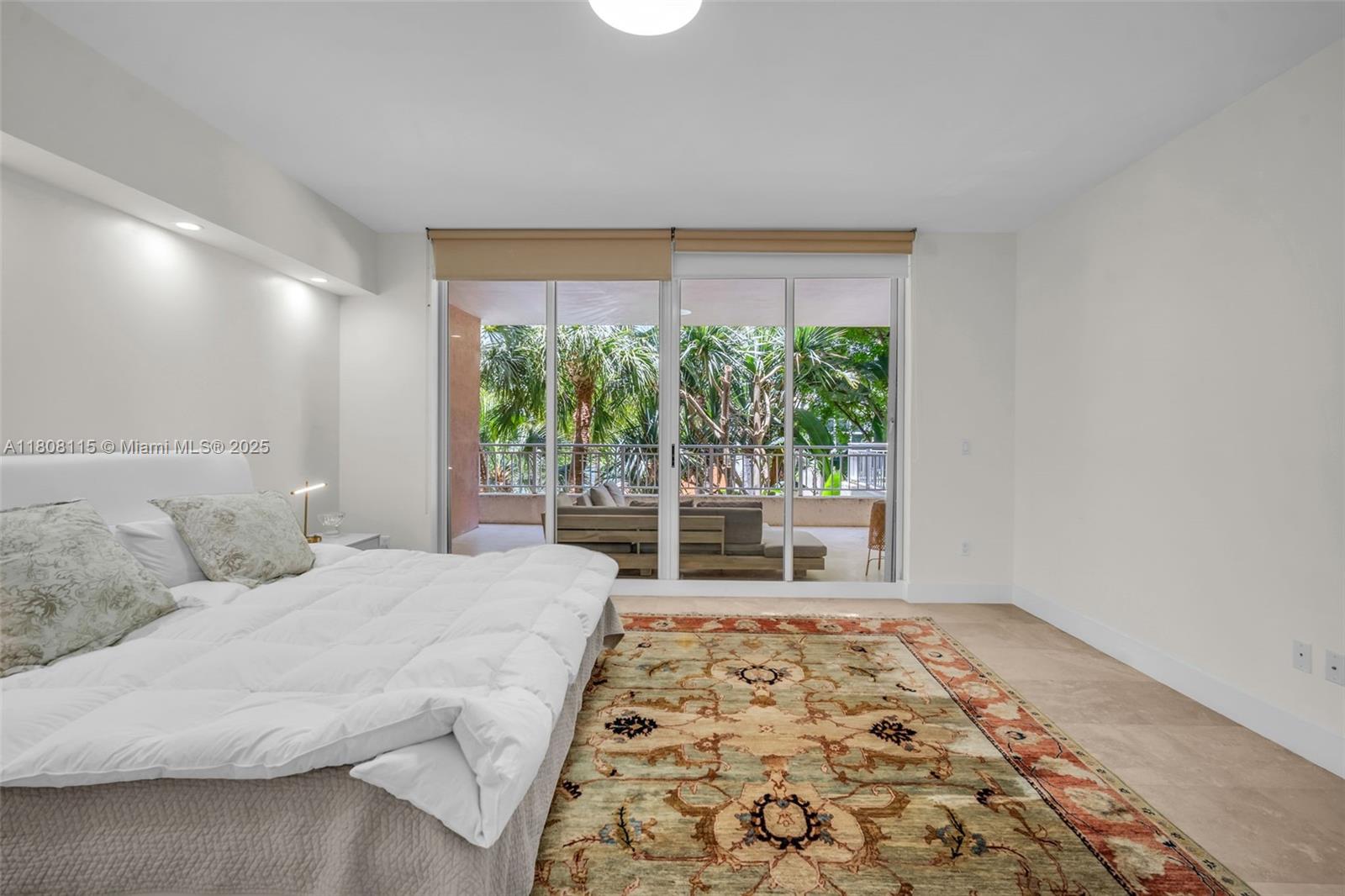 765 Crandon Boulevard, Unit 109 Key Biscayne, FL 33149 - Photo 11 of 21 a bedroom with a bed and a window