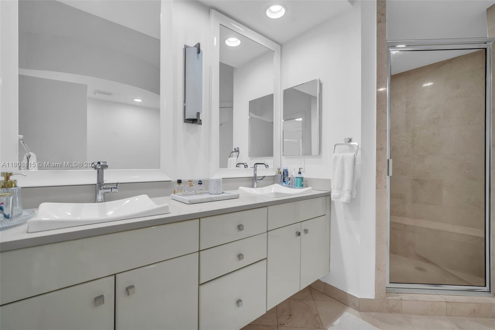 765 Crandon Boulevard, Unit 109 Key Biscayne, FL 33149 - Photo 12 of 21 a bathroom with double sink and a mirror