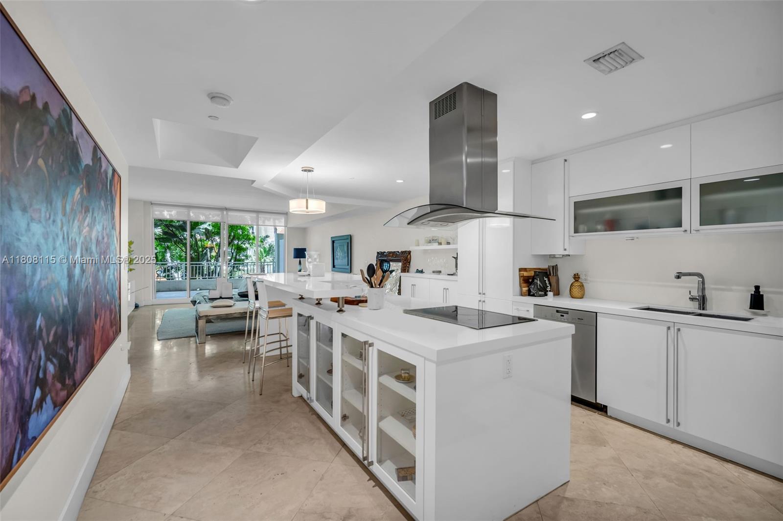 765 Crandon Boulevard, Unit 109 Key Biscayne, FL 33149 - Photo 4 of 21 a kitchen with appliances a sink a counter top space and a center island