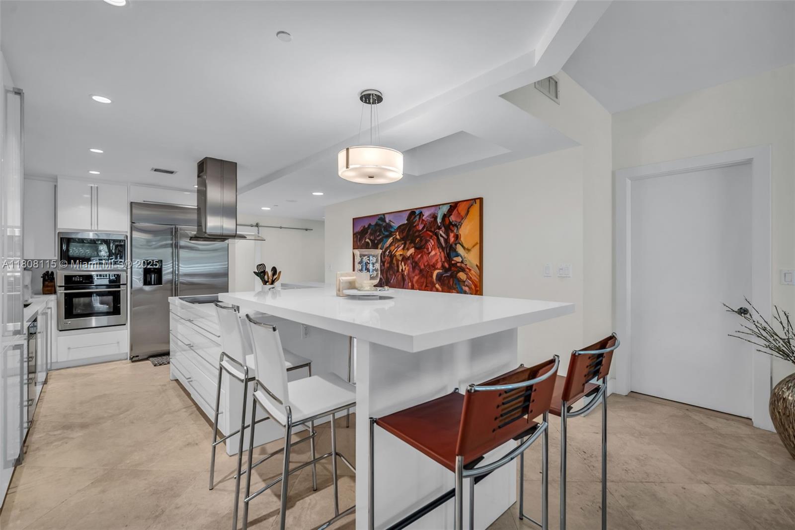 765 Crandon Boulevard, Unit 109 Key Biscayne, FL 33149 - Photo 6 of 21 a kitchen with stainless steel appliances kitchen island granite countertop a sink and cabinets