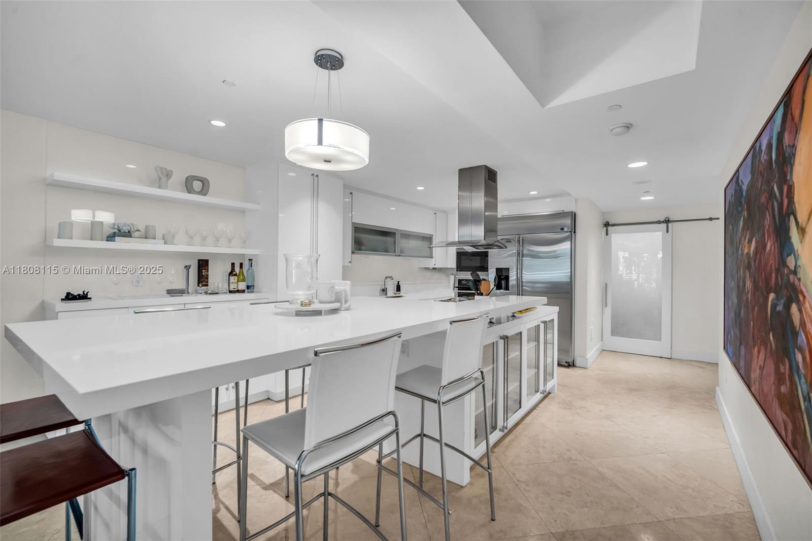 765 Crandon Boulevard, Unit 109 Key Biscayne, FL 33149 - Photo 7 of 21 a kitchen with stainless steel appliances kitchen island a chandelier