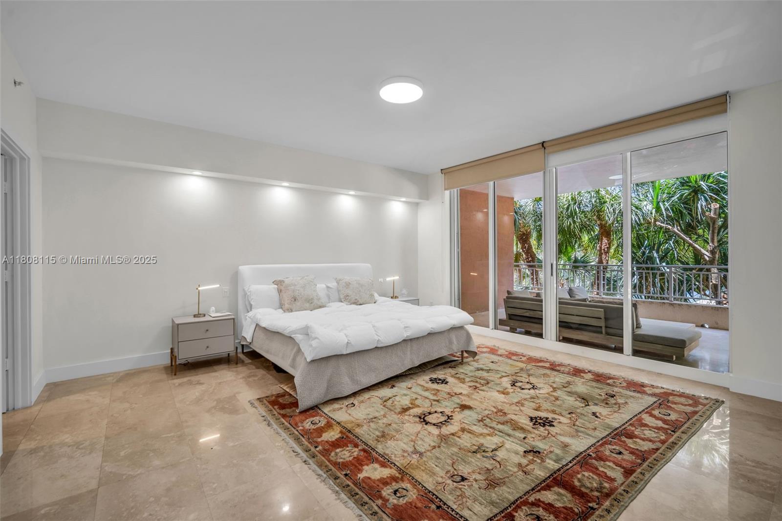 765 Crandon Boulevard, Unit 109 Key Biscayne, FL 33149 - Photo 10 of 21 a bedroom with a bed and wooden floor