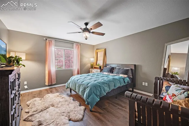 a bedroom with a bed and a flat tv screen on dresser