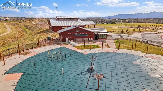 a view of a swimming pool with a lawn chair and ocean view