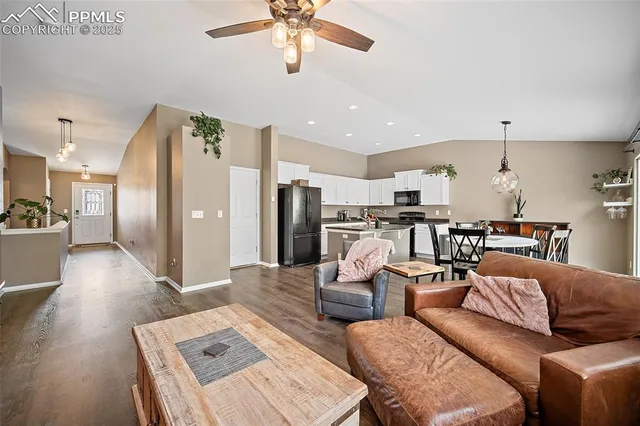 a living room with furniture and kitchen view
