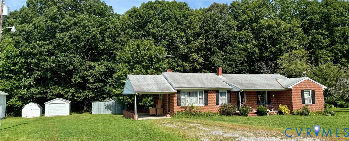 a front view of a house with a yard porch and outdoor seating