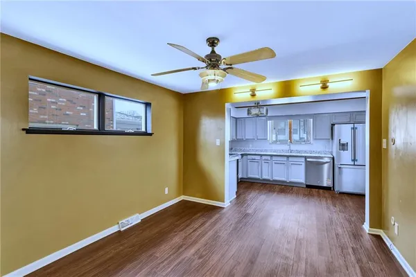 a room with wooden floors and pool table