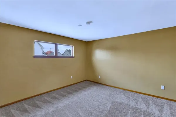 an empty room with a window and a projector