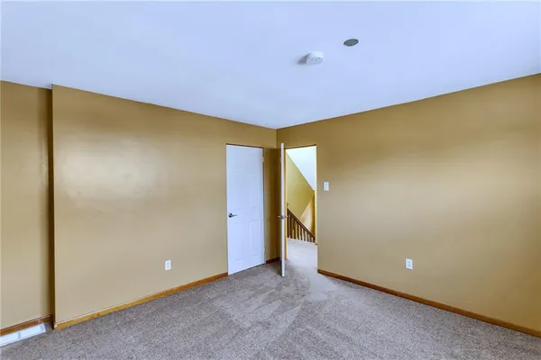 a view of livingroom with painted wall and a large window