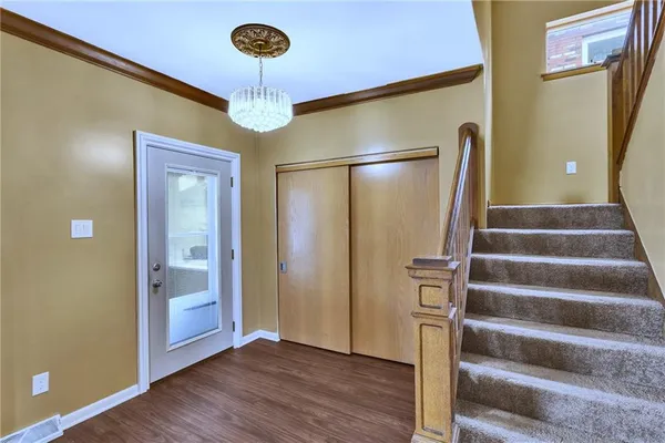 a view of an entryway with wooden floor