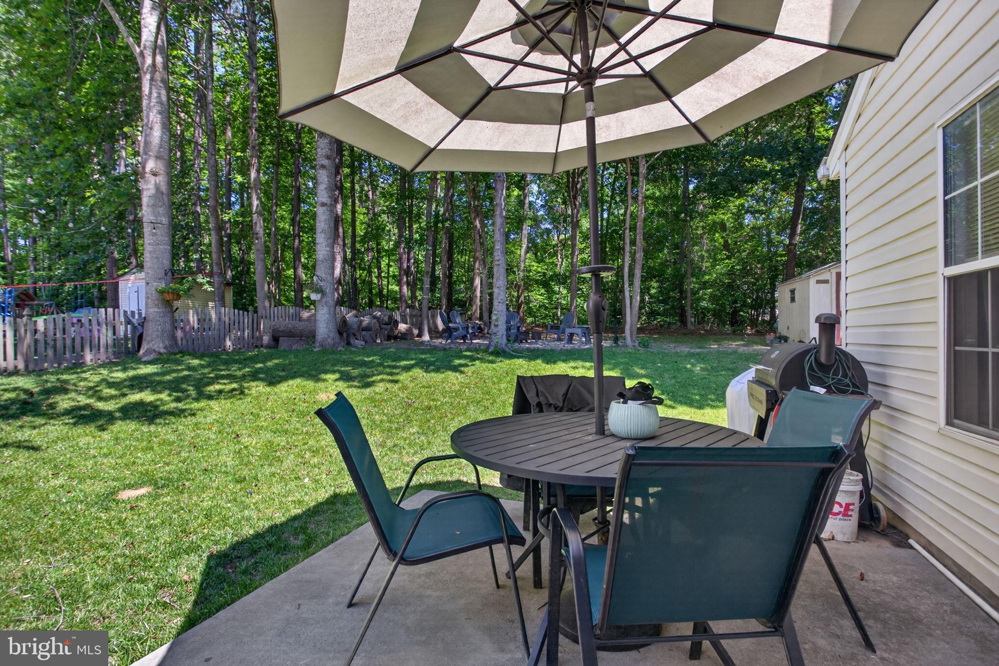 3917 Longhill Station Road Williamsburg, VA 23188 - Photo 21 of 29 Serene patio retreat in lush greenery.