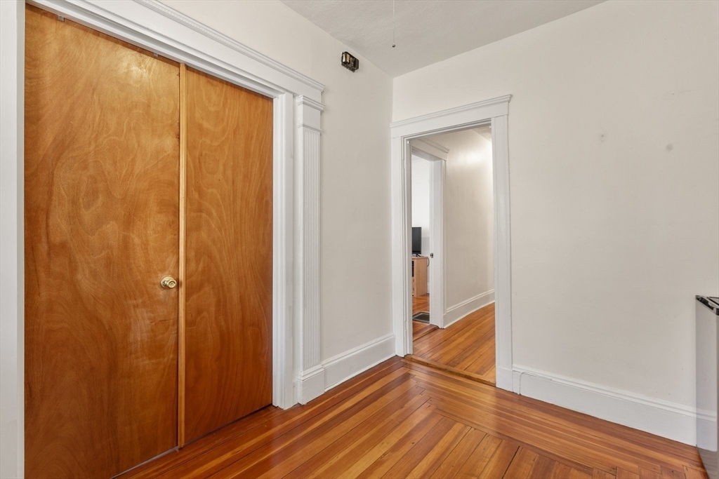 28 Pearson Road, Unit 1 Somerville, MA 02144 - Photo 11 of 18 a view of an empty room with wooden floor and a window