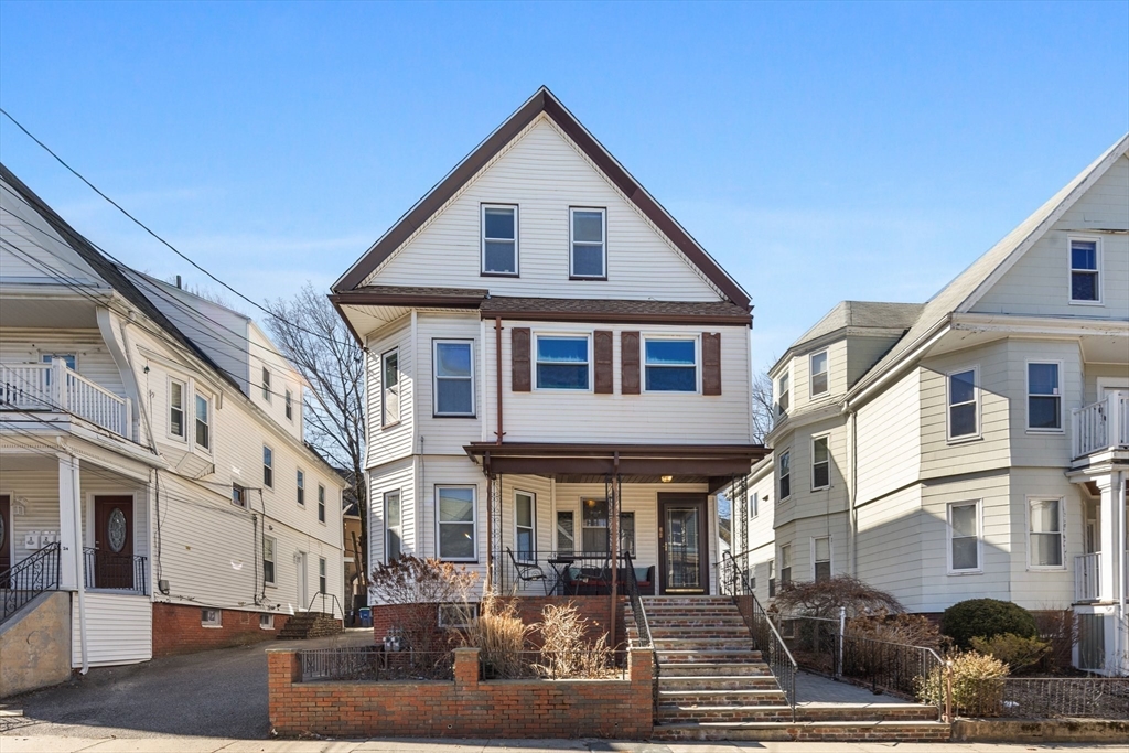 28 Pearson Road, Unit 1 Somerville, MA 02144 - Photo 16 of 18 a front view of a building with lot of cars parked