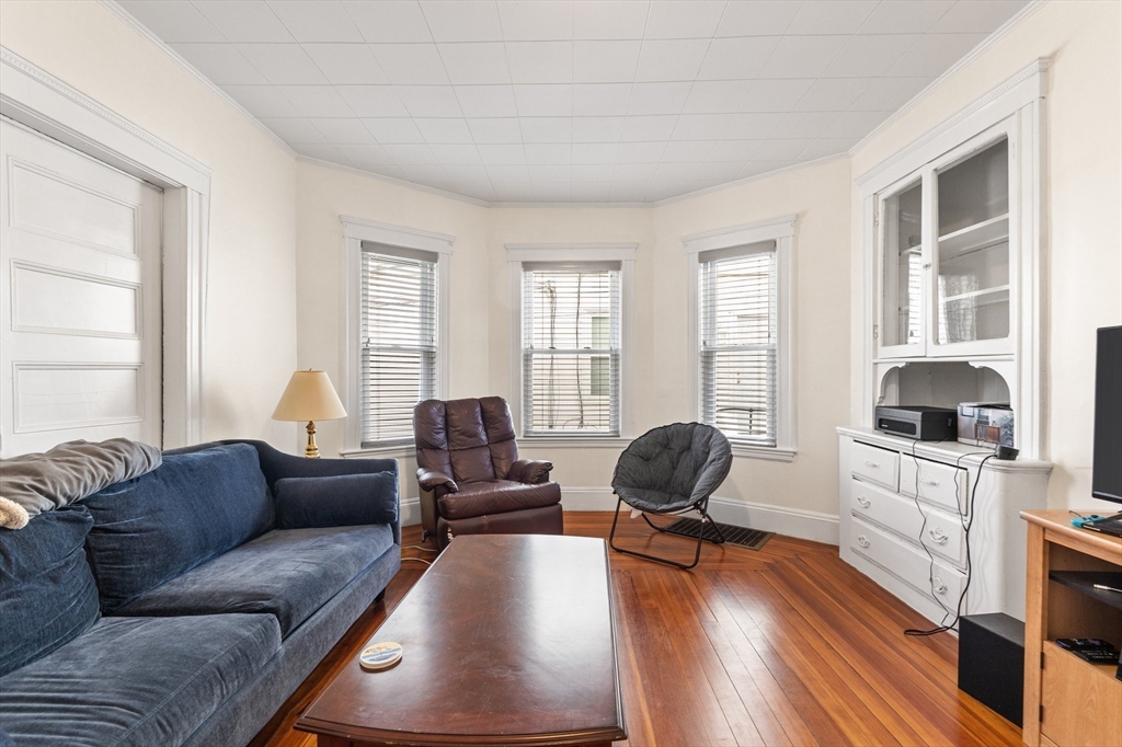 28 Pearson Road, Unit 1 Somerville, MA 02144 - Photo 2 of 18 a living room with furniture and wooden floor