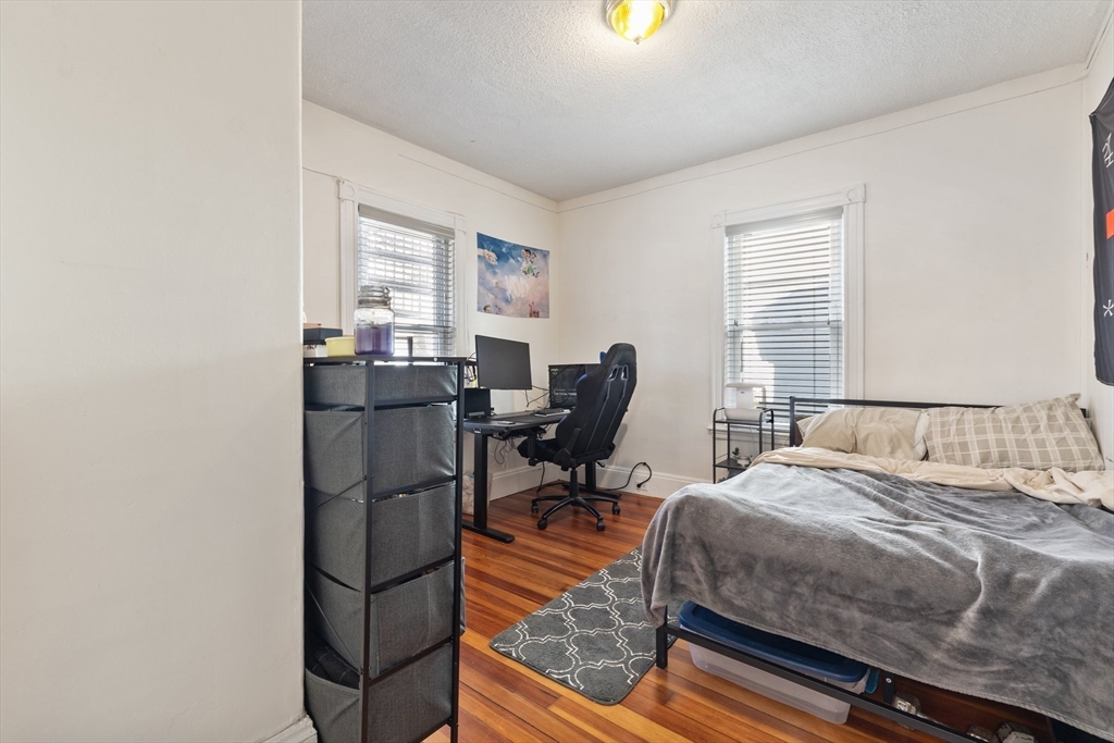 28 Pearson Road, Unit 1 Somerville, MA 02144 - Photo 6 of 18 a bedroom with a bed and wooden floor