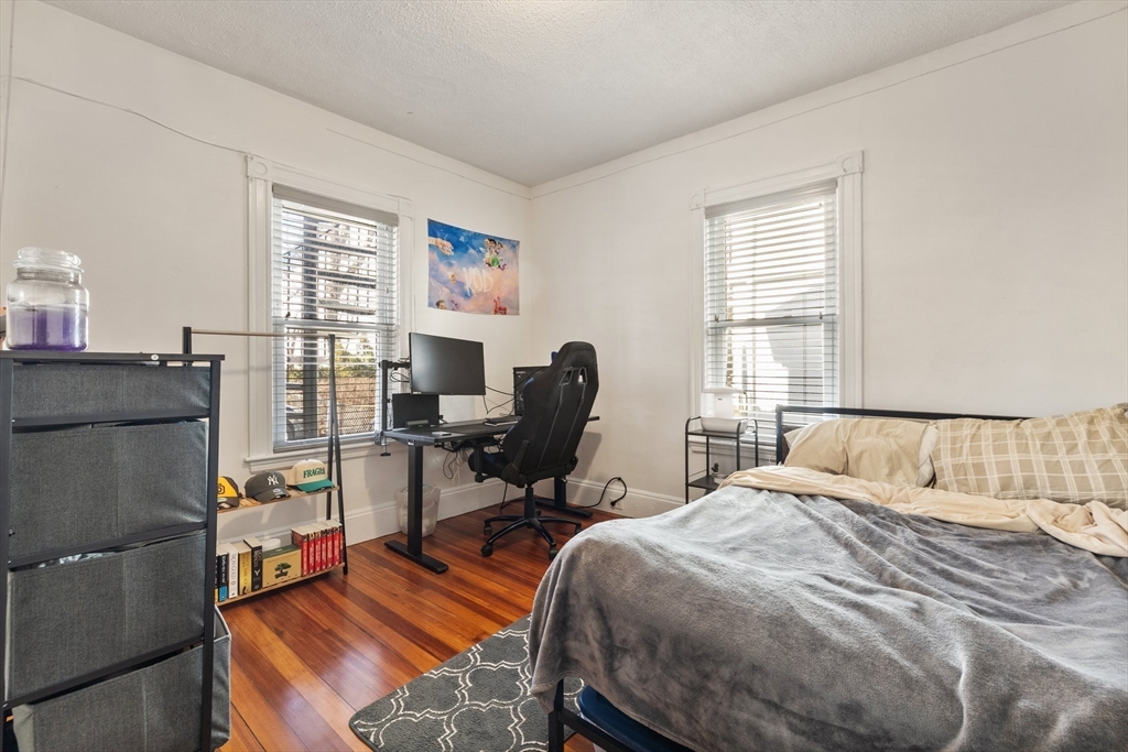 28 Pearson Road, Unit 1 Somerville, MA 02144 - Photo 7 of 18 a bedroom with a bed and wooden floor