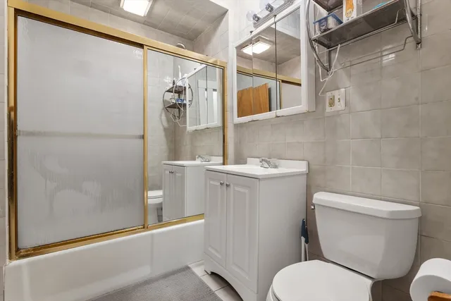 a white toilet sitting next to a bathroom sink
