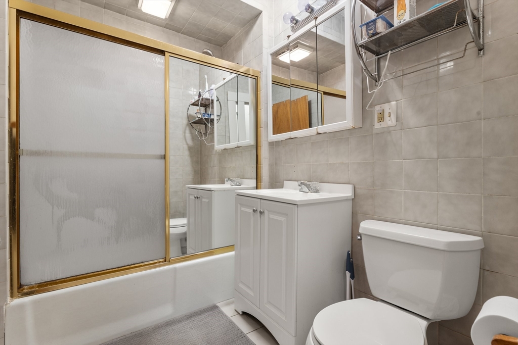 28 Pearson Road, Unit 1 Somerville, MA 02144 - Photo 8 of 18 a white toilet sitting next to a bathroom sink