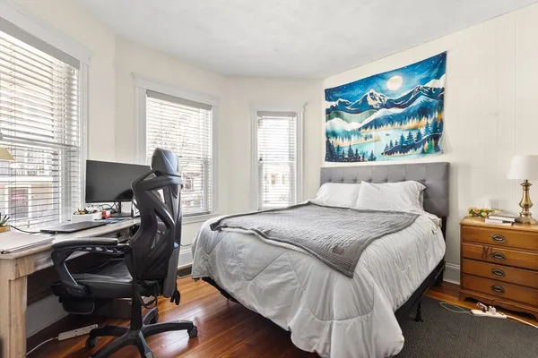 a bedroom with a bed and a desk