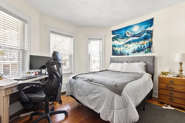 a bedroom with a bed and a desk