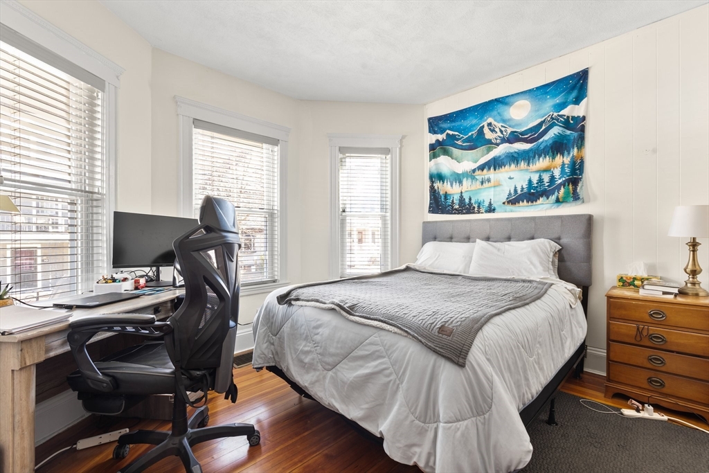 28 Pearson Road, Unit 1 Somerville, MA 02144 - Photo 10 of 18 a bedroom with a bed and a desk