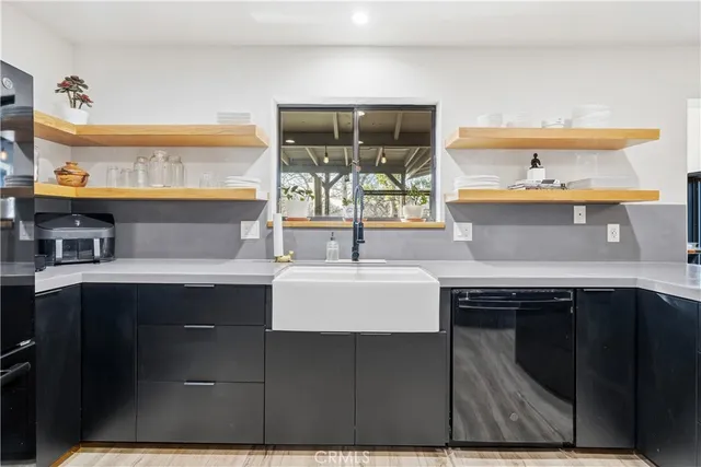 a kitchen with stainless steel appliances kitchen island granite countertop a sink counter space and cabinets