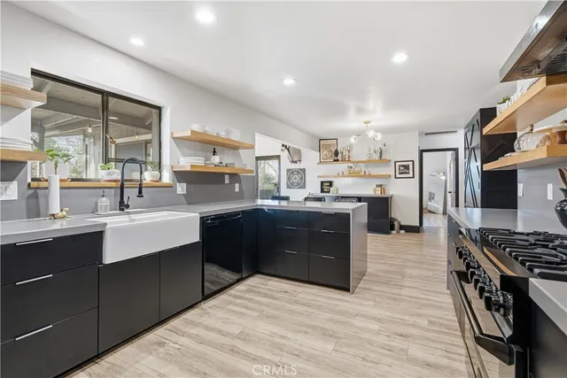 a kitchen with stainless steel appliances granite countertop a stove and a refrigerator