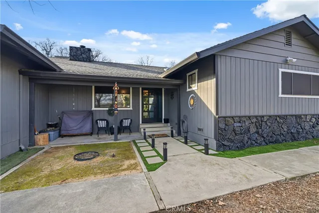 a view of a house with swimming pool and sitting area