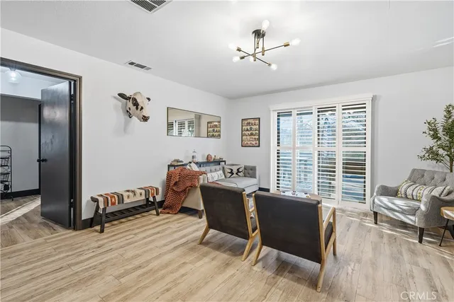 a view of a hallway with wooden floor and closet