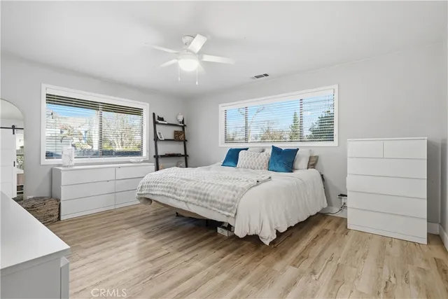 a bedroom with a large bed and a chandelier