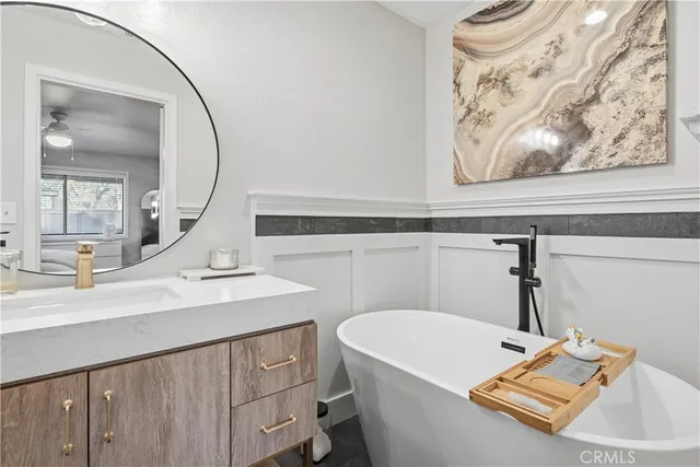 a living room with furniture a flat screen tv and a window