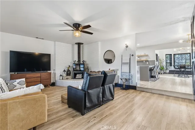 a living room with stainless steel appliances kitchen island granite countertop furniture and a kitchen view